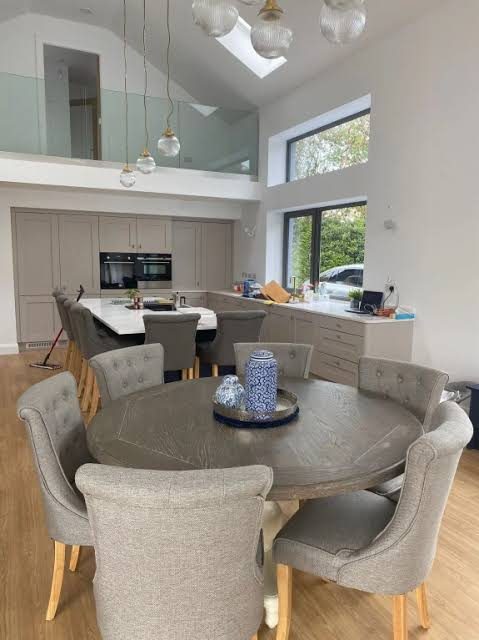 Open-plan kitchen and dining area with vaulted ceiling